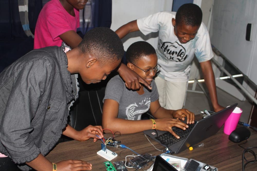 Students at YIL building circuits and writing code together